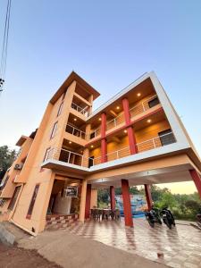 a building with two motorcycles parked in front of it at Horizon cottage in Nagaon