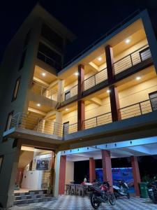 a building with two motorcycles parked in front of it at Horizon cottage in Nagaon