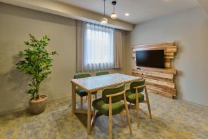 a conference room with a table and chairs and a television at WAYPOINT TSUKIJI Tokyo in Tokyo +17 photos