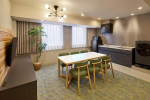 a kitchen with a table and chairs in a room at WAYPOINT TSUKIJI Tokyo in Tokyo