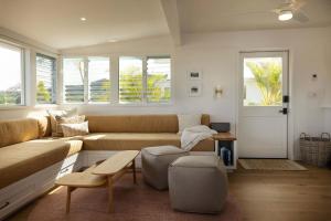 a living room with a couch and a table at Cottage Three - Hidden Gem on Hanalei River in Hanalei +28 photos