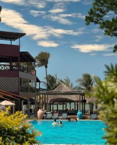 a group of people in a swimming pool at a resort at Hotel Velejar in Cumbuco