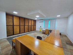 a conference room with a large wooden table in it at Hotel Velejar in Cumbuco +143 photos