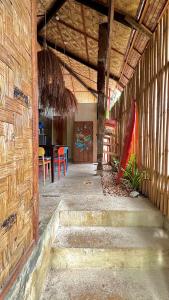 a room with stairs and a table and a surfboard at Ginhawa Stay Mixed dorm 6 Bed in Burgos