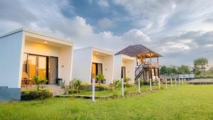 a house in the middle of a field at Swarga Rinjani in Sembalun Lawang