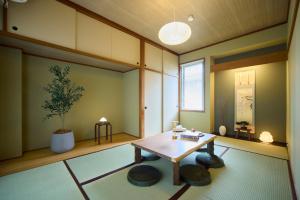 a living room with a table and two stools at TOMARIE Rooftop House Skytree in Tokyo