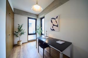 an office with a black desk and some plants at TOMARIE Rooftop House Skytree in Tokyo