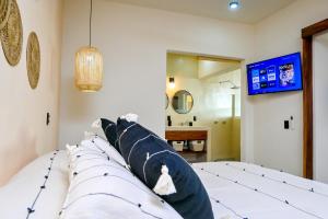 a bedroom with a bed with blue and white pillows at Punta Peñasco Villas in Zihuatanejo