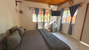 a living room with a couch and a window at Paradise Beach Bacalar A Pie De Laguna in Bacalar