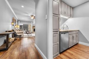an open kitchen with stainless steel appliances and a living room at Comal Rive Pool Gruene Hall by Barclé in New Braunfels