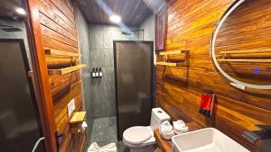 a bathroom with wooden walls and a toilet and a sink at Paradise Beach Bacalar A Pie De Laguna in Bacalar +84 photos