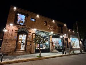 a brick building with a store on a street at night at El depto de Bowie in Santa Rosa de Calamuchita