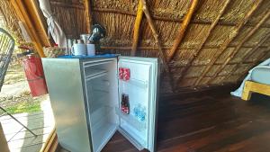 a refrigerator freezer sitting inside of a room at Paradise Beach Bacalar A Pie De Laguna in Bacalar