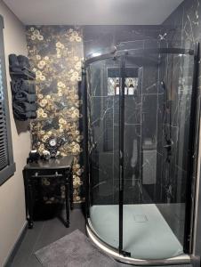 a bathroom with a shower with a black tile wall at The Raven in Madison +41 photos