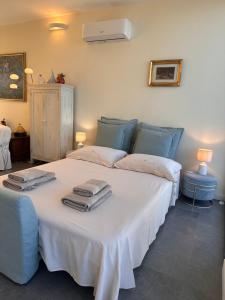 a bedroom with two beds with towels on them at La mia terrazza sul mare - Mared'aMare in Bari