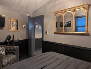 a bedroom with a bed and a mirror on the wall at The Raven in Madison