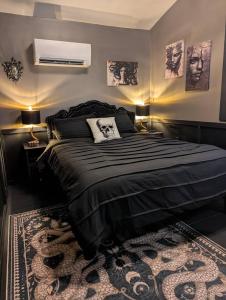 a bedroom with a black bed and a rug at The Raven in Madison