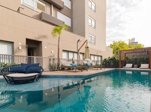 a swimming pool in front of a building at Studio 208 Premium 450m do Consulado EUA in Porto Alegre