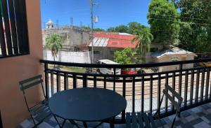 a table and chair on a balcony with a view at ANDABAY Tourist Inn in Anda