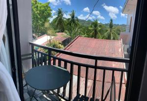 a balcony with a chair and a view of a roof at ANDABAY Tourist Inn in Anda