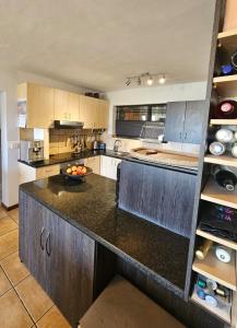 a large kitchen with a counter top in a room at Marine View in Plettenberg Bay