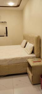 a bedroom with a bed with a cover on it at Hotel Seven View Lahore in Lahore