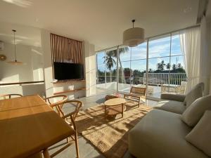 a living room with a couch and a table at Blue Garden Villa A in Ban Madua Wan