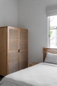 a bedroom with a bed and a wooden cabinet at Blue Garden Villa A in Ban Madua Wan +15 photos