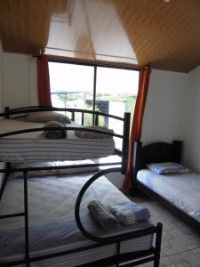 two bunk beds in a room with a window at Conchal Maquito House in Brasilito