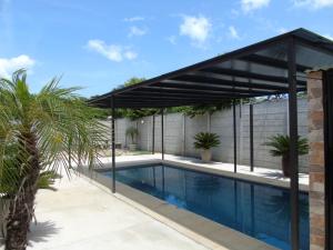 a pavilion over a swimming pool in a house at Conchal Maquito House in Brasilito