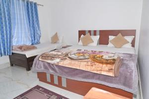a bedroom with two beds and a window at Trance Himalaya in Gupta Kāshi +5 photos