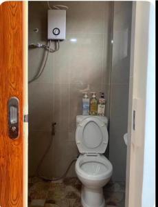 a bathroom with a white toilet in a stall at Studio Apartment in Mactan,Cebu Room203 in Lapu Lapu City
