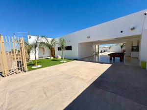 a large living room with a pool table in a house at Casa Flamingo, San Carlos in San Carlos
