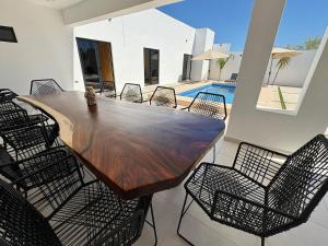 a large wooden table and chairs on a patio at Casa Flamingo, San Carlos in San Carlos