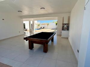a pool table in the middle of a living room at Casa Flamingo, San Carlos in San Carlos