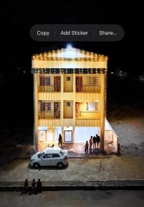 a group of people standing in front of a building at Saiprasad suite & stay in Ellora