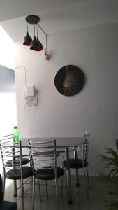 a dining room table with chairs and a plate on the wall at Serene Cove Homestay in Dispur