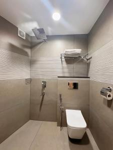 a bathroom with a toilet and a shower at Mezkar Residency in Alwaye +26 photos