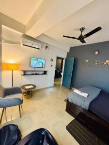 a living room with a bed and a ceiling fan at Serene Cove Homestay in Dispur