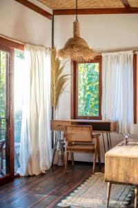 a room with a desk and a window at Hidden Paradise West Sumbawa Yo Yos in Sekongkang Bawa