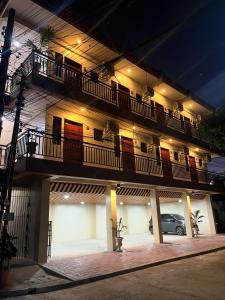 a building with balconies and a car parked in front of it at Studio Apartment in Mactan, Cebu Room304 in Lapu Lapu City