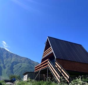 a house with solar panels on the side of it at LizMari in (( Gergeti ))