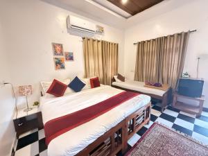 a bedroom with a large bed and a tv at RnB Beach Resort in Anjuna