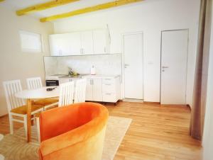 a kitchen and dining room with a table and chairs at Kucica na Drini MINJA in Višegrad