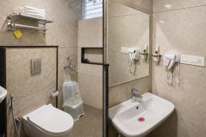 ein Badezimmer mit Waschbecken und Toilette in der Unterkunft DeVerveil Service Apartment in Mysore + 29 Fotos