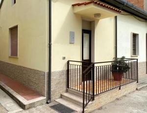 a porch of a house with a black railing at Casa tranquilla e indipendente in Reggio di Calabria