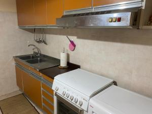 a small kitchen with a stove and a sink at Casa tranquilla e indipendente in Reggio di Calabria