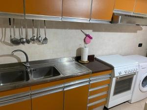 a kitchen with a sink and a washing machine at Casa tranquilla e indipendente in Reggio di Calabria +19 photos