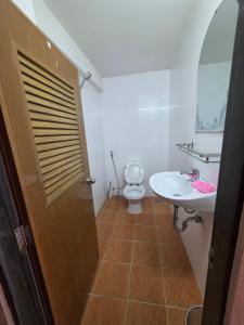 a bathroom with a toilet and a sink at Toul Sleng Double Room in Phnom Penh +1 photo