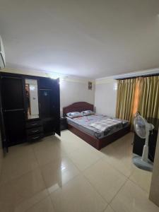 a bedroom with a bed and a dresser at Toul Sleng Double Room in Phnom Penh
